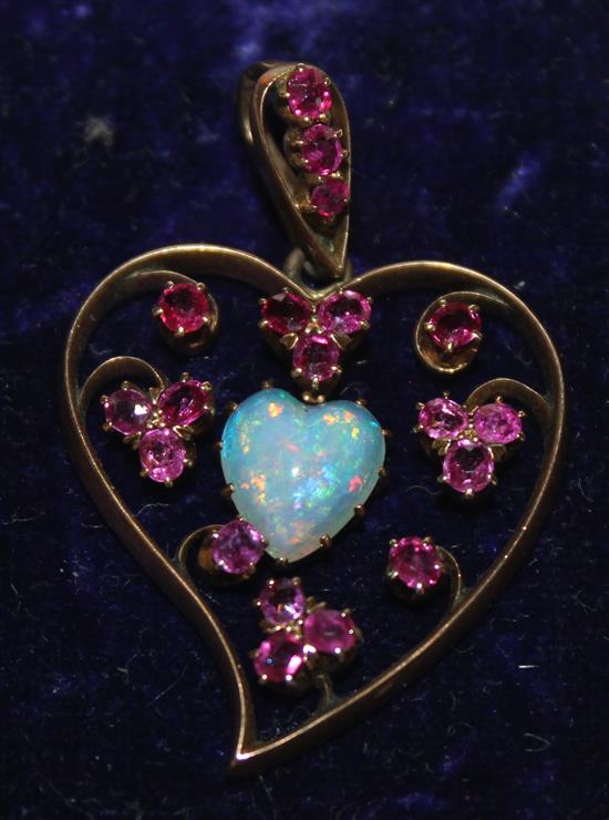 Gold heart shaped pendant set with white opal and pink stones